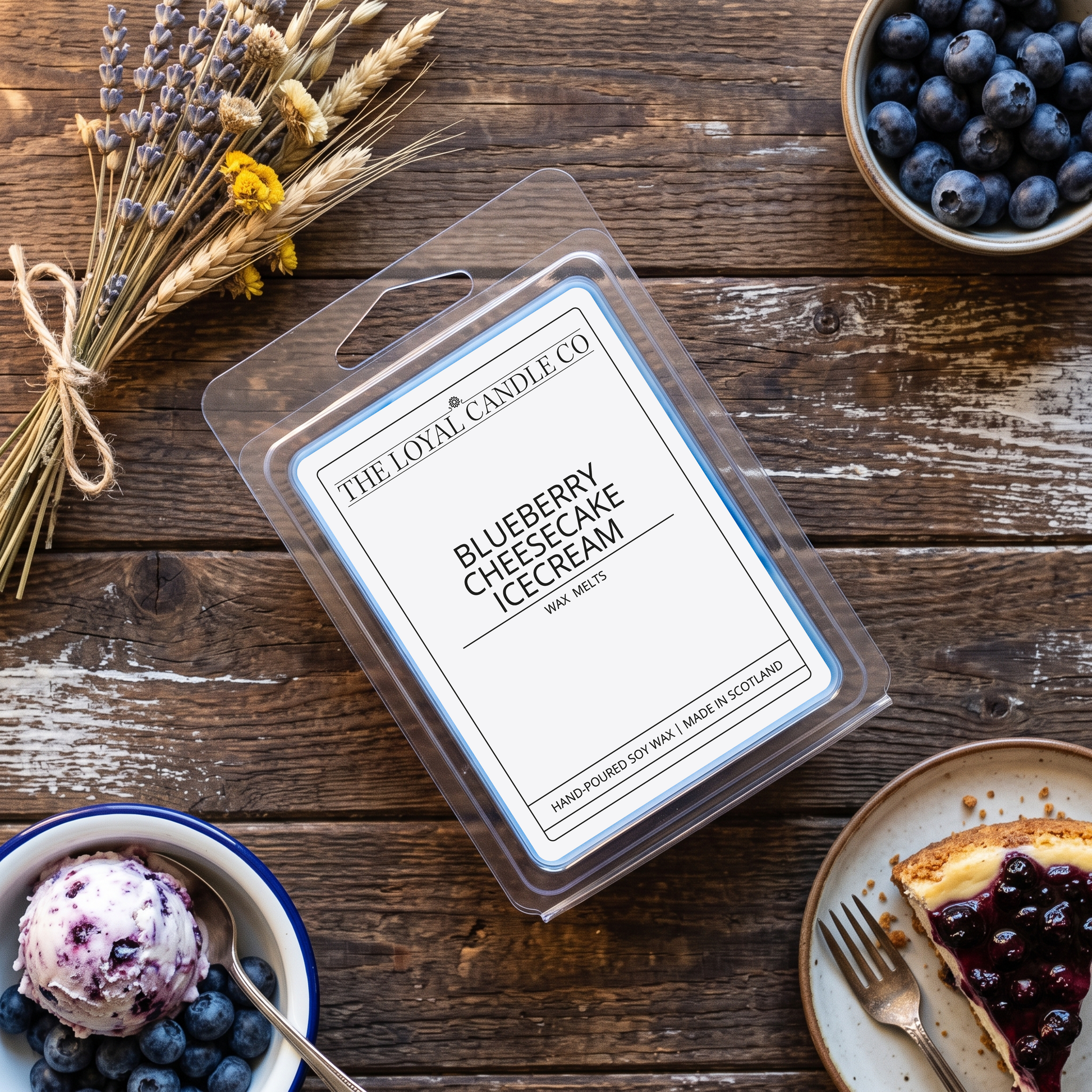 Blueberry Cheesecake Ice Cream wax melt clamshell on a dark wood background