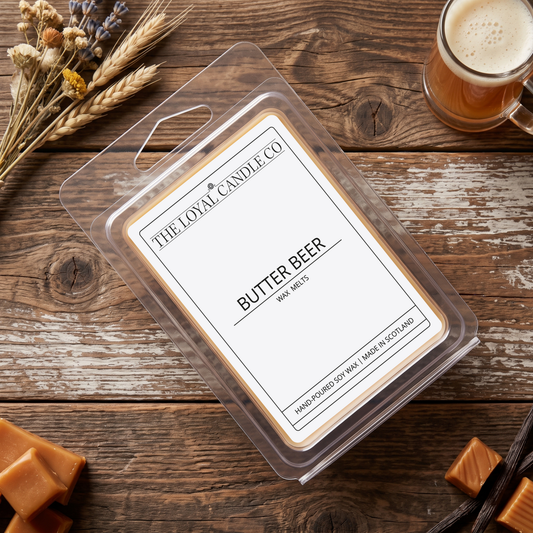 Butter Beer wax melt clamshell on a dark wood background