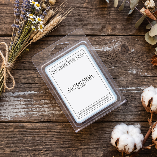 Cotton Fresh wax melt clamshell with linen fabric on a dark wood background