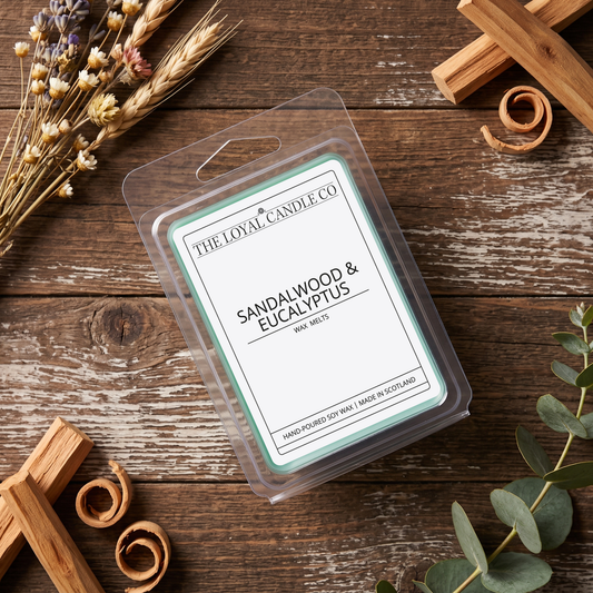 Sandalwood & Eucalyptus wax melt clamshell on a dark wood background