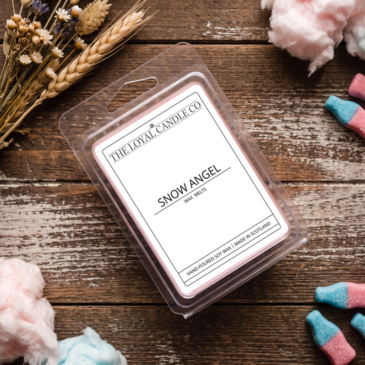 Snow Angel wax melt clamshell on a dark wood background.